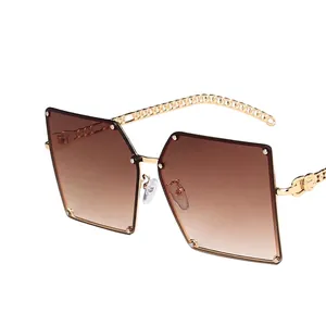 Fashionable oversized square sunglasses with gold chain temples and gradient brown lenses