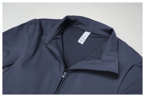 Detail of navy yoga jumpsuit neckline with smooth zipper and size tag for fitness