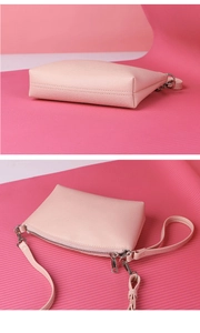 Detail of pink lychee leather texture and durable silver zipper on the crossbody bag