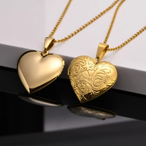 Polished gold heart locket pendants with intricate floral engraving and smooth finish