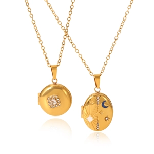 Golden locket necklaces with celestial sun moon star patterns and crystals on white backdrop
