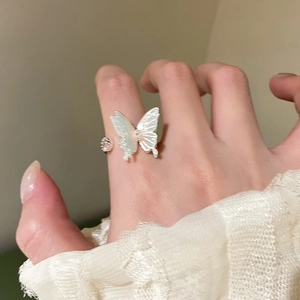 Detailed macro of silver butterfly open ring with mother of pearl finish and zircon