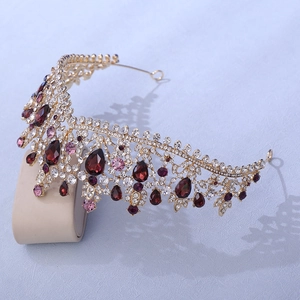 Elegant gold bridal tiara featuring teardrop red gems and sparkling clear rhinestones