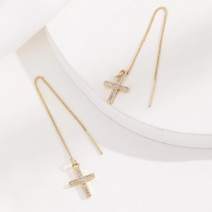 Exquisite gold cross threader earrings with micro-paved zircons on a white background