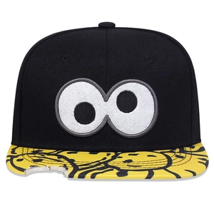 Detail of snapback cap with large eye embroidery and yellow brim featuring a unique bite mark