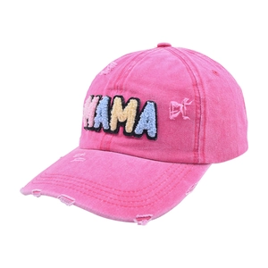 Close-up of pink washed cotton baseball cap with colorful MAMA embroidery and distressed holes