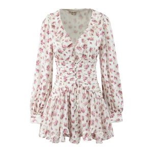 Close-up of floral print dress with ruffled V-neckline and delicate buttoned front details