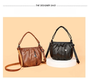 Detailed view of pleated leather handbags in black and brown with metal pendant details