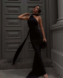 Detail of elegant black backless halter gown with a long decorative ribbon side drape