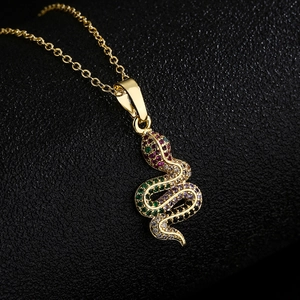 18K gold plated copper snake pendant necklace with multi-color zircon stones on black background