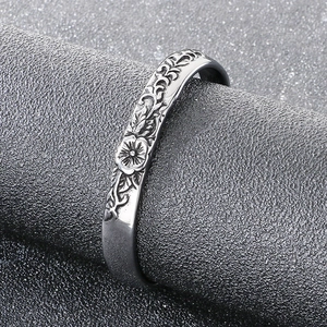Macro shot of vintage floral carvings on ancient silver-colored titanium steel bangle