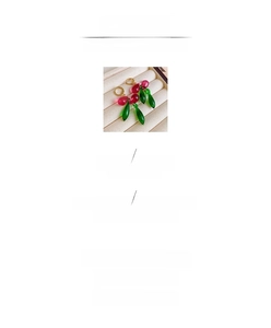 Detail view of handmade pomegranate drop earrings with red glass beads and copper hooks