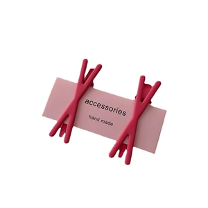 Set of two pink candy-colored crossover hair clips on cardstock for women's hairstyling