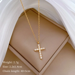 Macro view of gold cross pendant with crystal inlay and technical specifications