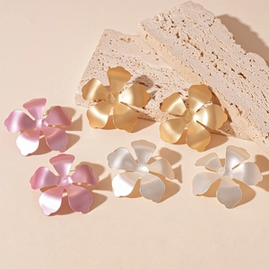 Matte floral stud earrings in gold, silver and pink metal finish on stone pedestals