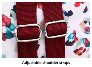 Close-up of adjustable red woven shoulder straps with silver buckles on floral backpack