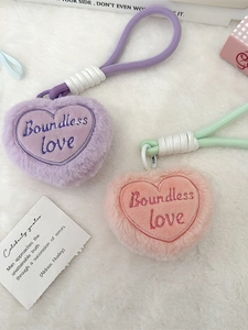 Plush heart keychains with Boundless Love embroidery on a white soft faux fur background