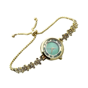 Elegant gold women's watch with green dial and sparkling diamond flower bracelet