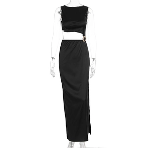 Detail of waist cutout with golden metal ring on a black sleeveless maxi dress