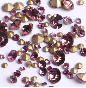 Macro detail of purple and gold crystal rhinestones with sparkling multifaceted cut