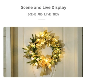 Golden Christmas wreath with LED lights, baubles and large ribbon on a white door