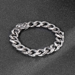 Detailed close-up of a silver stainless steel dragon scale link chain bracelet for men