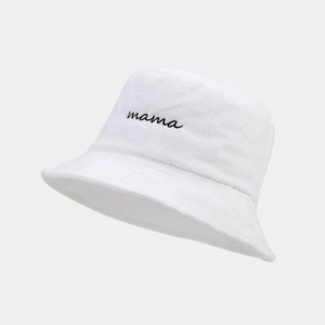 Detailed close-up of white terry cloth bucket hat with black mama embroidery