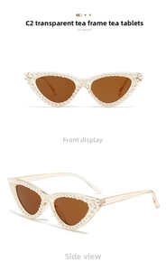 Detail view of tea-colored cat eye sunglasses featuring elegant pearl-embellished frames