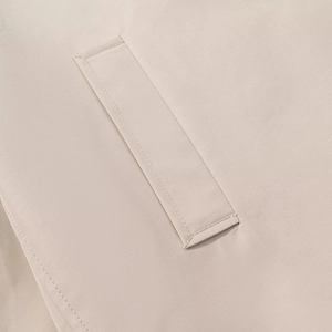 Macro view of high-density khaki twill fabric and reinforced stitching on pocket edge