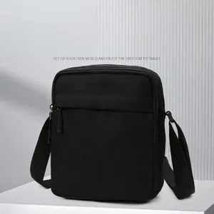 Minimalist black canvas shoulder bag for men with adjustable strap and front zipper pocket