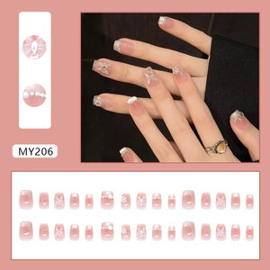 Pink gradient press-on nails with butterfly, pearls, and rhinestones in 24pc set