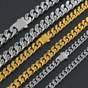 Detailed close-up of Cuban link chains in gold and silver with mechanical clasps