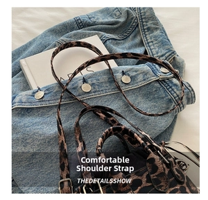 Close-up of leopard print handbag featuring adjustable slim straps and leather texture