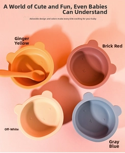 Overhead view of bear-eared silicone baby bowls with spoons in four Morandi colors