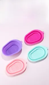 Collapsible silicone makeup brush cleaning bowls in four colors with textured bottom