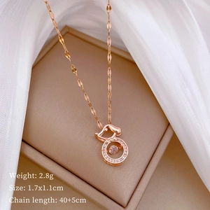 Detail view of rose gold gourd pendant with rhinestones on a jewelry display