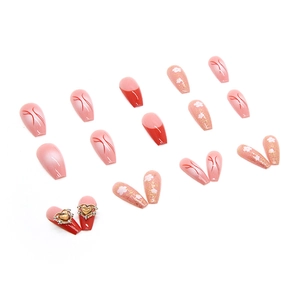 Glossy pink and red press-on nails with heart rhinestones and floral patterns