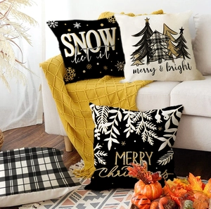 Detail of four Christmas pillow covers with reindeer and snowflake prints on linen fabric
