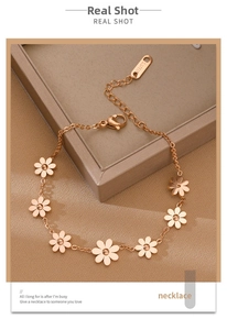 Close-up of rose gold daisy bracelet showing the lobster clasp and S.Steel hallmark