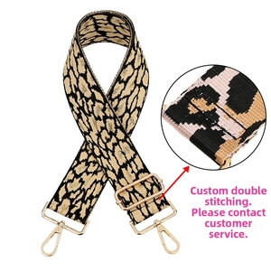 Detail of leopard print woven bag strap with adjustable gold buckle and lobster clasp