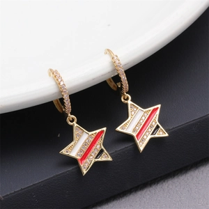 Macro shot of gold star earrings with striped enamel inlay and diamond accents