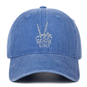 Front detail of washed blue denim baseball cap with Good Vibes skull hand embroidery