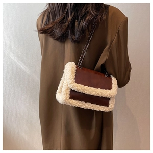 Detailed back view of model wearing a vintage brown leather bag with faux fur trim