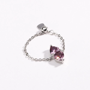 Detailed close-up of adjustable silver chain ring with double purple heart-shaped stones