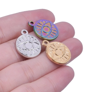 Macro view of stainless steel evil eye pendants in silver, gold, and rainbow finishes