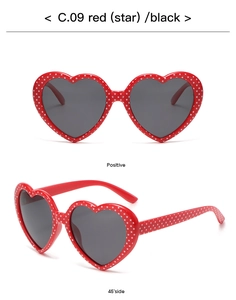 Red heart-shaped sunglasses with white star patterns shown in front and 45-degree side views