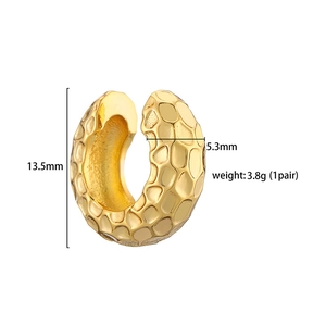 Macro detail of gold-plated C-shaped ear cuff with vintage hammered texture and dimensions