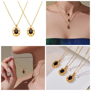 Detail of vintage oval black zircon pendant necklace in gold-tone stainless steel finish
