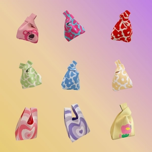 Detail view of nine knit tote bags featuring strawberry bear and floral patterns