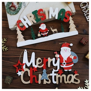 Close-up of Merry Christmas wooden pendant with Santa Claus and reindeer on wood table